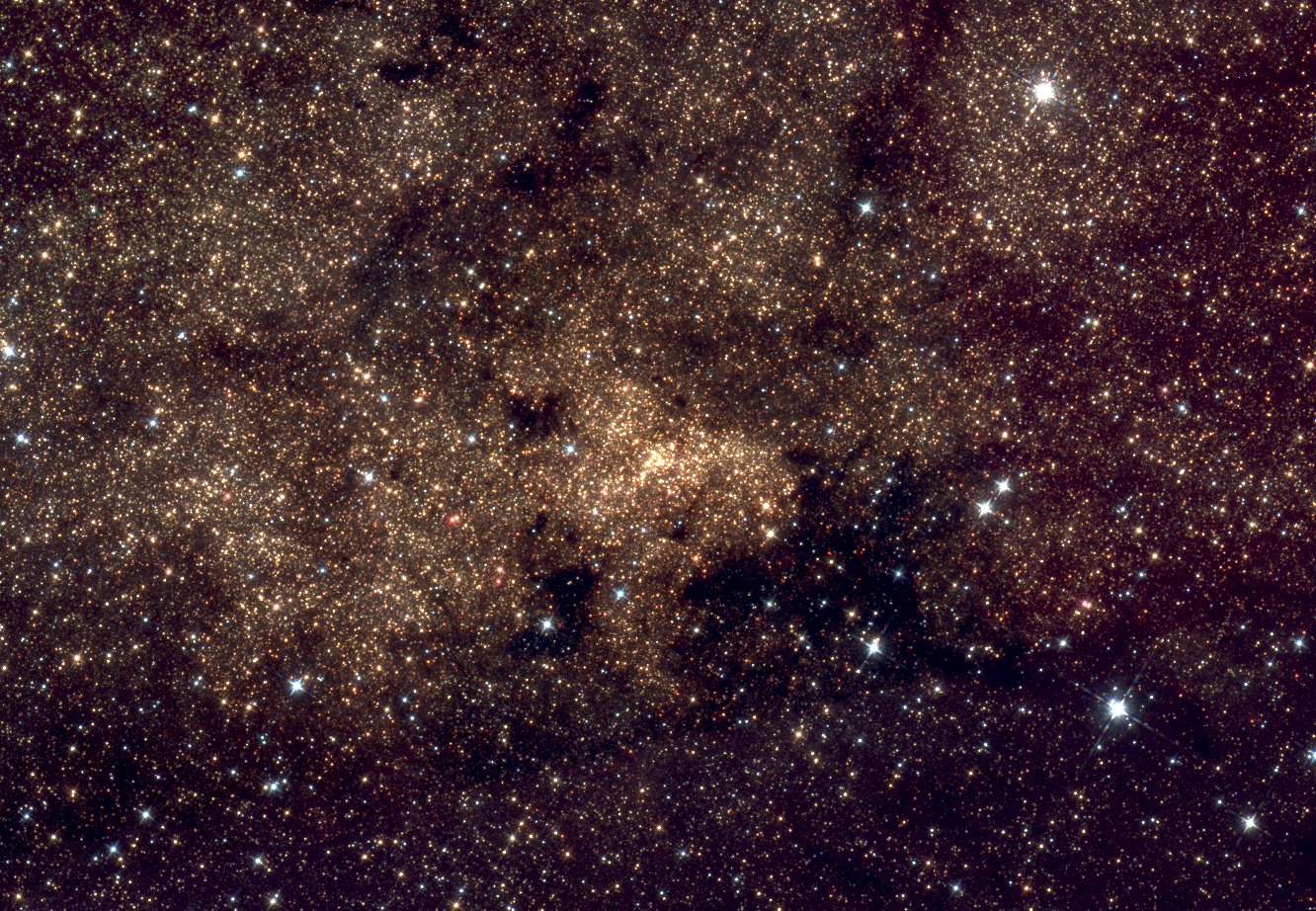 Hubble Space Telescope near-infrared image of the nuclear star cluster, a dense concentration of stars around Sgr A* with dark dust lanes crossing the field.
